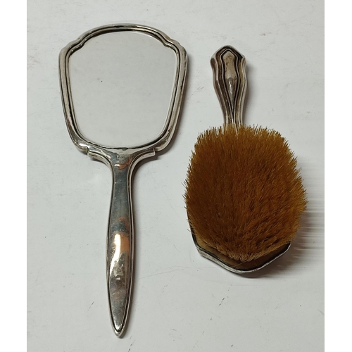 271 - A Silver vanity set comprising of a hand held mirror and brush (2)

465 grams gross