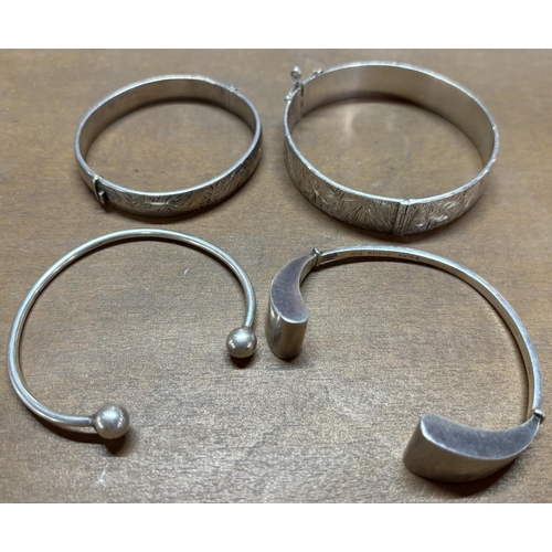 12 - Four silver bangles 1 finely carved (4)