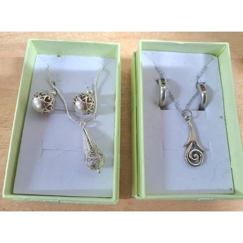 35 - Two silver necklaces' both with pendants and matching earrings and both in presentation boxes (2)