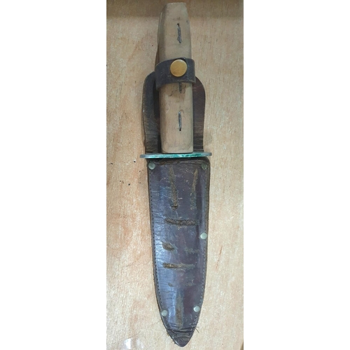 146 - Mid 20thC unmarked Bowie style knife with homemade wooden handle (possibly later) and original leath... 