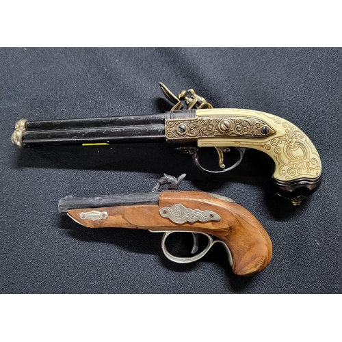 198 - Pair of Replica pistols one being a flintlock and the other a percussion cap (2)