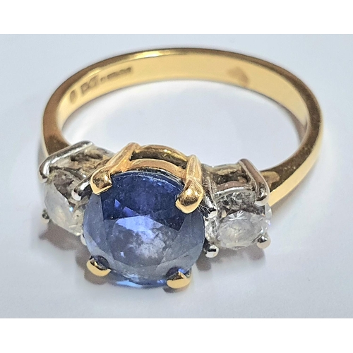 28 - 18ct yellow gold ring set with a central round cut Sapphire (approx 2.2cts) flanked to either side b... 