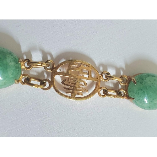 45 - Hong Kong spinach green jadeite and unmarked yellow metal mounted bracelet,

9.5 grams gross        ... 