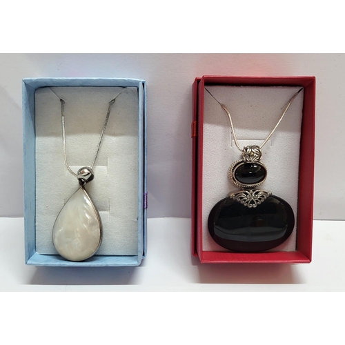 36 - Two silver necklaces both with large stone pendants and both in presentation boxes (2)