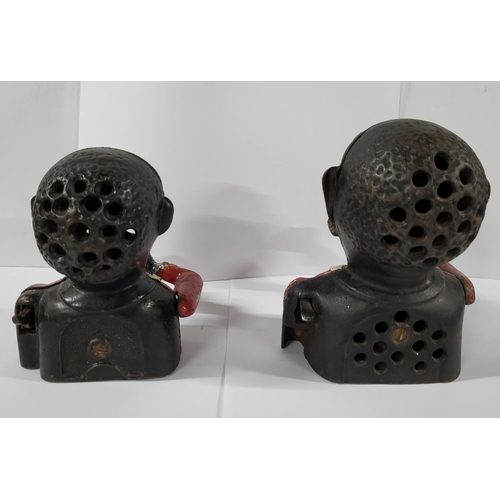 51 - Two cast iron money boxes both containing coins (2)