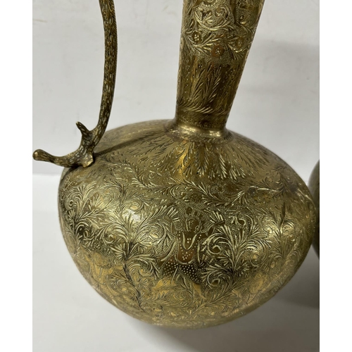 180 - Pair of brass snake handled jugs 

38cm Tall