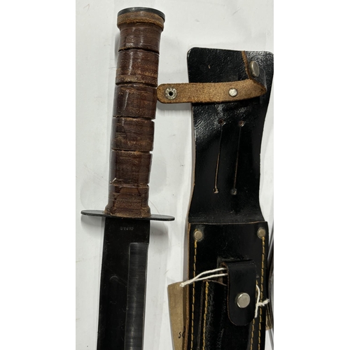 182 - Two Kukri knives and a Bowie-style knife, all in sheaths (3)