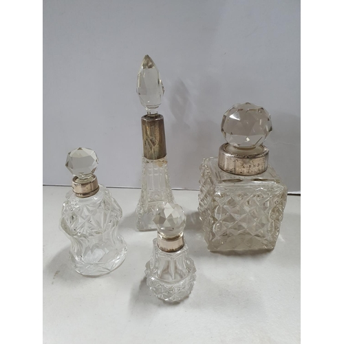 14 - Four small silver necked, cut-glass ladies toilet bottles (4)