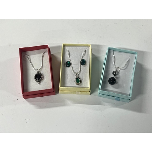 75 - Silver green stone pendant  with earrings along with 2 other silver necklaces