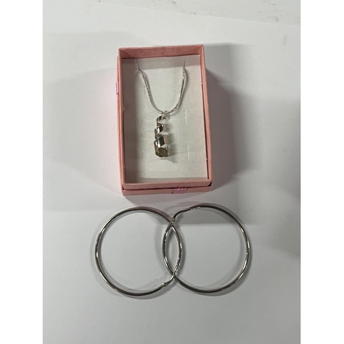 78 - Silver pendant on chain with hoop earrings along with 2 other pendants on chains (3)