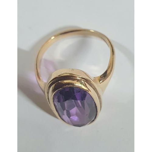 79 - 9ct yellow gold ring set with a large oval cut Amethyst,

4.9 grams gross              Size J