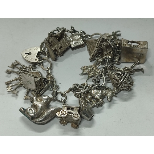 58 - A fine quality Silver charm bracelet with many charms