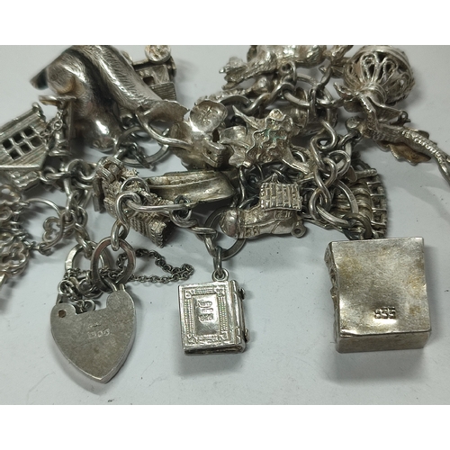 58 - A fine quality Silver charm bracelet with many charms