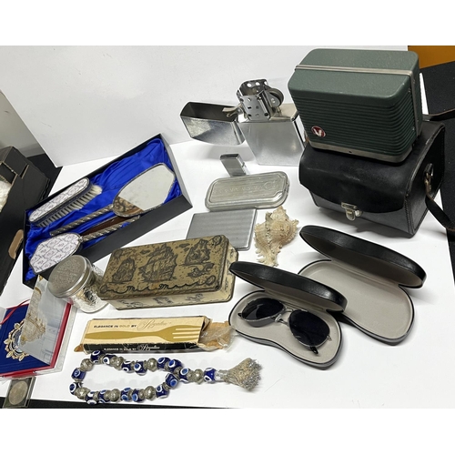 214 - Qty of items including vanity set, lighters, 2002 White House Christmas ornament, Ray Ban cases etc ... 