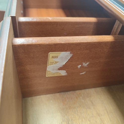 604 - A Rossmere sideboard comprising of three drawers above three doors with brass handles