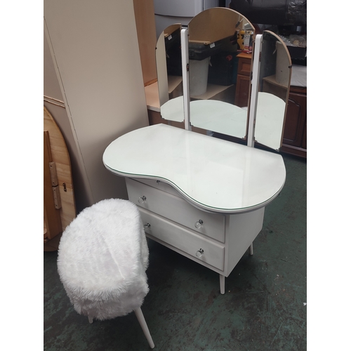 606 - A kidney shaped dressing table with tri-folding mirror and stool