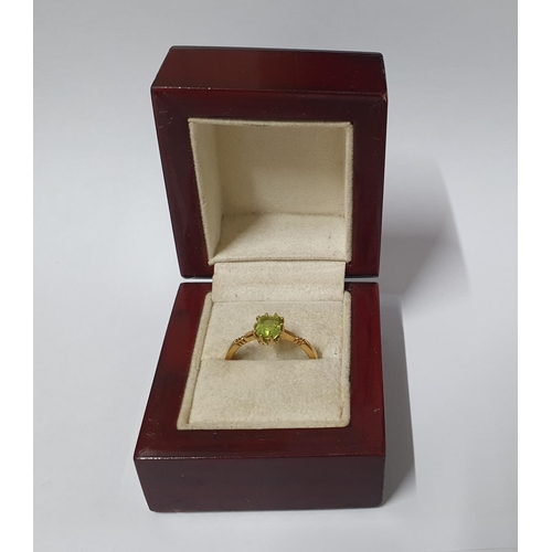 28 - 18ct stamped ring with solitaire green, Peridot type stone,

3.2 grams gross       size P