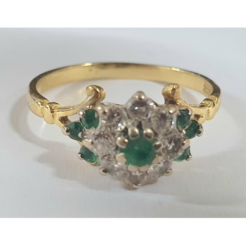 90 - yellow gold metal ring stamped 18kt with an Emerald and Diamond flower head caped with a central rou... 