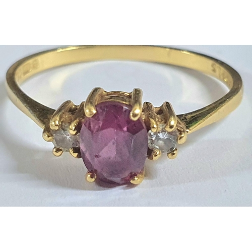 92 - Fully hallmarked 18ct yellow gold ladies ring with a large oval cut garnet flanked to either side by... 