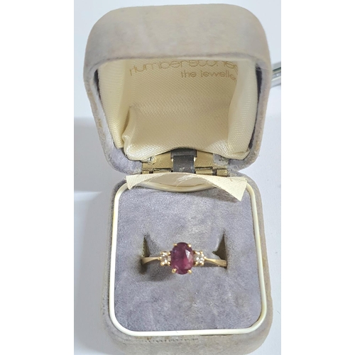 92 - Fully hallmarked 18ct yellow gold ladies ring with a large oval cut garnet flanked to either side by... 