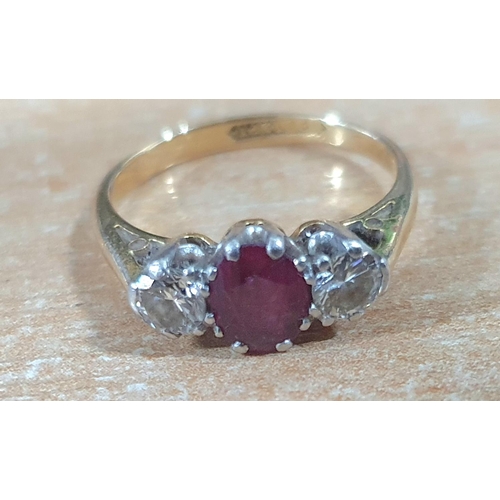 102 - 18ct gold ring with a large round cut Ruby flanked to either side by a round cut diamond and comes i... 