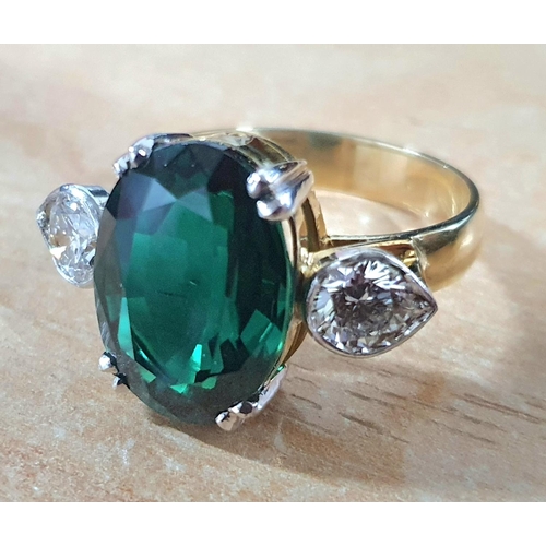 125 - 19.30ct oval Vivid Muzo Columbian green, recrystallised emerald master cut set in a ring with two si... 