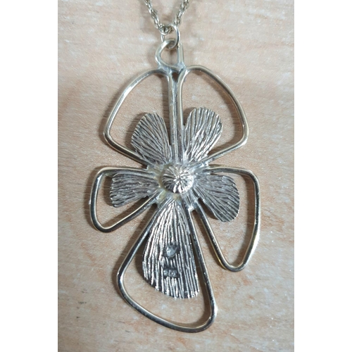 75 - Large flower petal pendant stamped 9ct on rope chain,

10.2 grams         56cm long