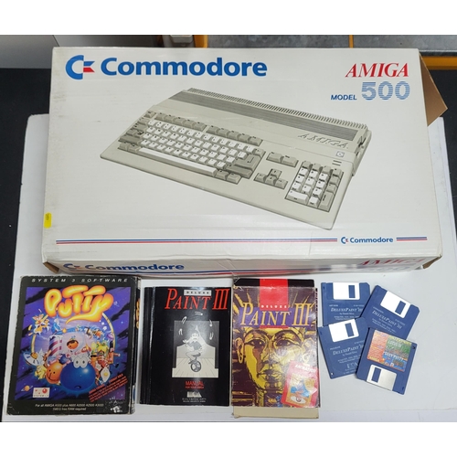 157 - Original boxed Commodore Amiga model 500 with a collection of various games