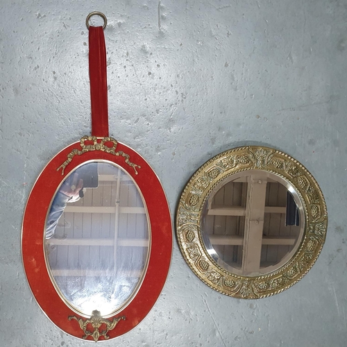221 - French style oval wall mirror together with a small circular mirror in beaten brass frame (2)