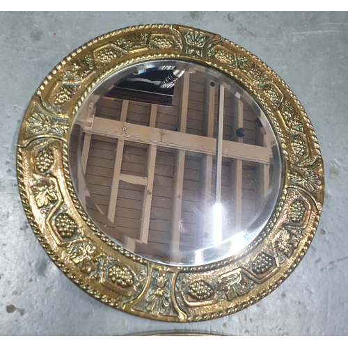 221 - French style oval wall mirror together with a small circular mirror in beaten brass frame (2)