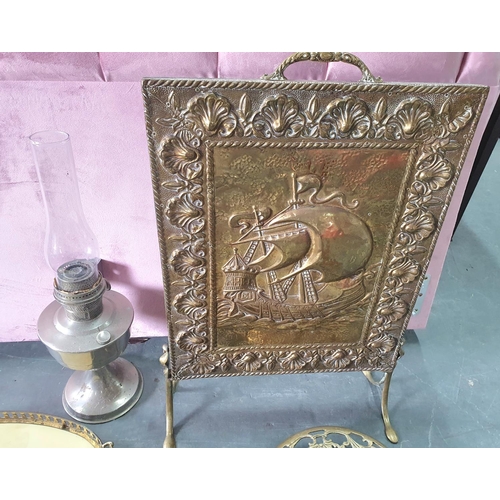 291 - Collection of metalware including a brass trivet on wheels, a brass fronted fire guard and an oil la... 