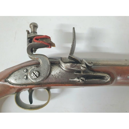 33 - A Georgian flintlock pistol by Henry Nock of London, 21cm barrel, brass trigger guard & ramrod with ... 