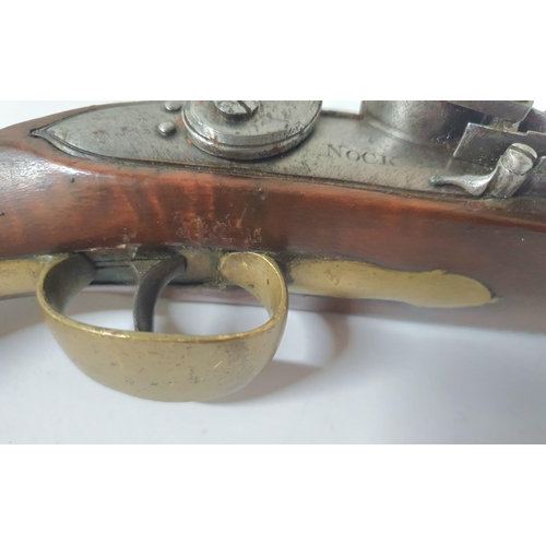 33 - A Georgian flintlock pistol by Henry Nock of London, 21cm barrel, brass trigger guard & ramrod with ... 