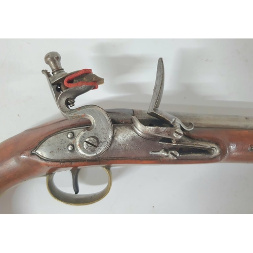 33 - A Georgian flintlock pistol by Henry Nock of London, 21cm barrel, brass trigger guard & ramrod with ... 