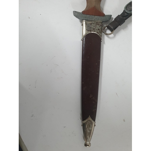 47 - NSKK dagger with cross-hatched carved wooden grip, the double-edged blade etched 