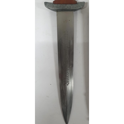 47 - NSKK dagger with cross-hatched carved wooden grip, the double-edged blade etched 