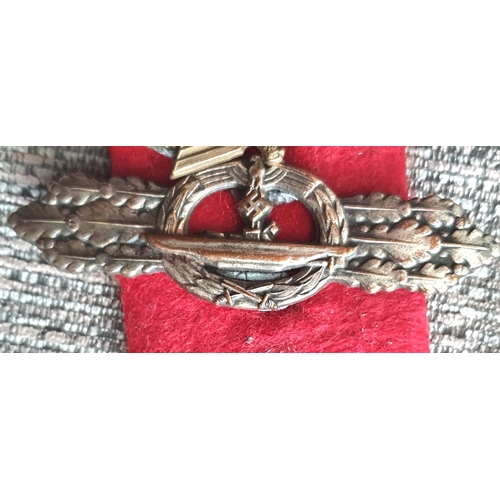 21 - Three WWII German cap badges to include a rare Kriegsmarine U-boat clasp in bronze 1st pattern by Sc... 