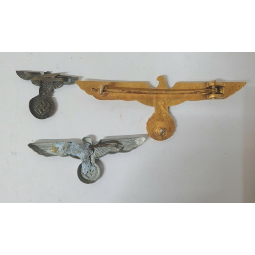 8 - Two German WWII spread Eagle cap badges together with a WW2 German Kriegsmarine gilt metal tunic che... 