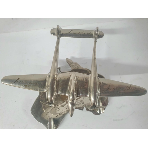 18 - Unusual WWII era silvered metal pen rest depicting aLockheed twin engined plane with the etched incr... 