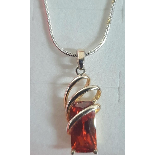 185 - Silver 925 red stone pendant on a chain along with pendant containing small crystals and bronze glit... 