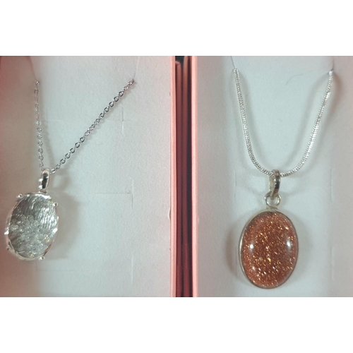 185 - Silver 925 red stone pendant on a chain along with pendant containing small crystals and bronze glit... 