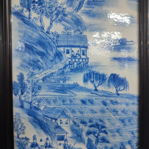 364 - Framed Chinese hand painted porcelain panel depicting a village scene, 

measures 22cm x 75cm