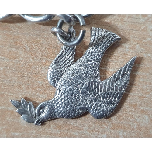 18 - Chunky silver charm bracelet with 5 large silver charms including a detailed large Dove in flight wi... 