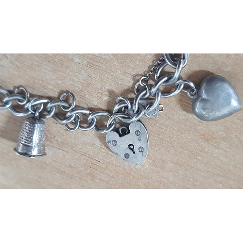 18 - Chunky silver charm bracelet with 5 large silver charms including a detailed large Dove in flight wi... 