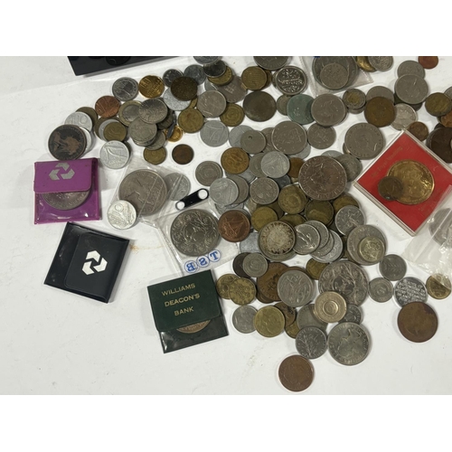 101 - Two metal cash tins containing GB coins and commemoratives and world coins (Qty)