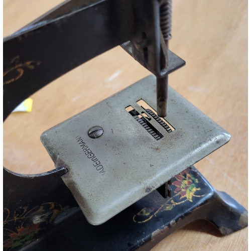 123 - Miniture sewing machine with German made tin plate