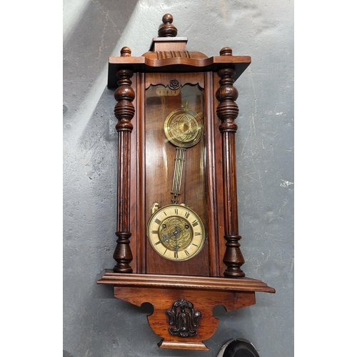 229 - Wall hanging clock with pendulum, measures 76cm