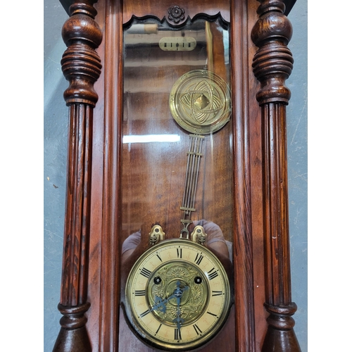 229 - Wall hanging clock with pendulum, measures 76cm