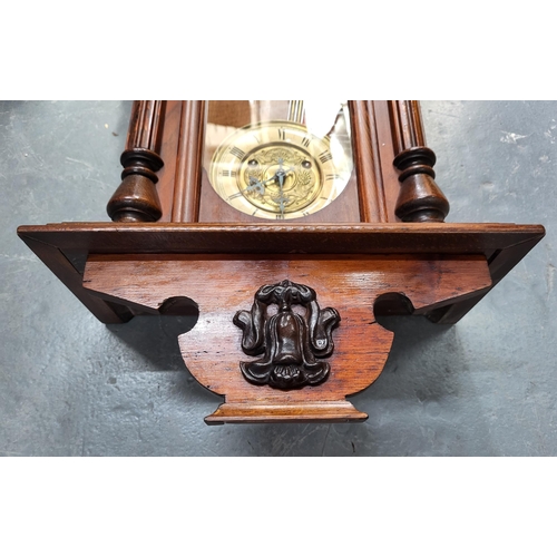 229 - Wall hanging clock with pendulum, measures 76cm