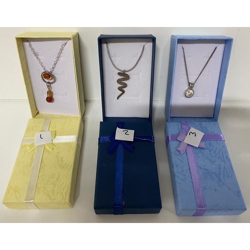 24 - Three 925 silver chains with varying pendants, including an amber pendant and crystal pendant (3)